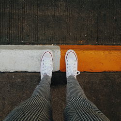 Low section of person standing on footpath