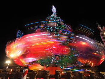 Low angle view of illuminated ferris wheel against sky at night