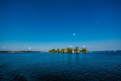 Scenic view of sea against blue sky