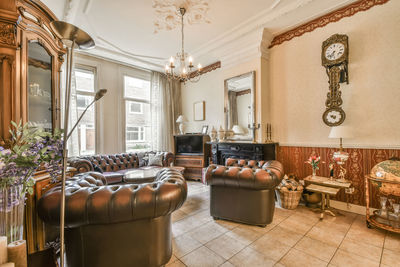 Empty chairs and tables and table and potted plant on floor at home