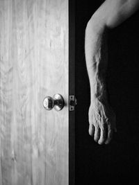 Low section of man standing by door