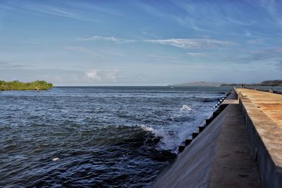 Water breaks on the sea port.