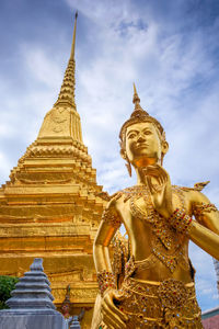 Low angle view of statue against temple building