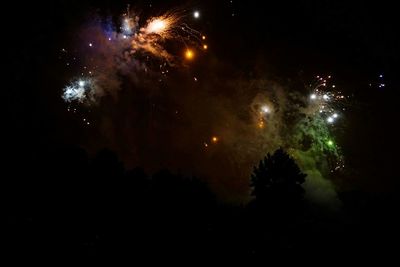 Low angle view of firework display at night