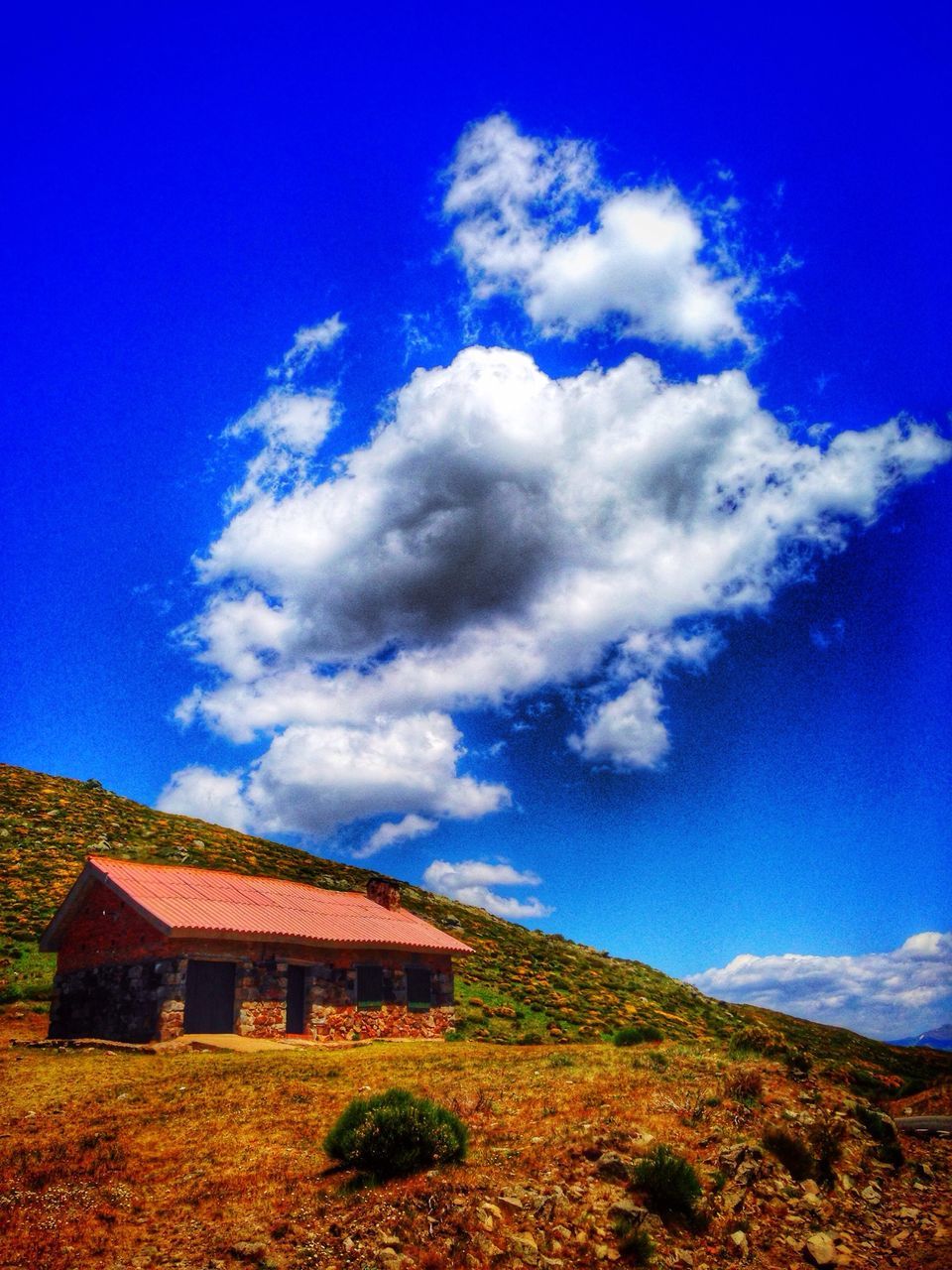 blue, sky, landscape, field, built structure, house, building exterior, cloud - sky, architecture, cloud, grass, rural scene, tranquil scene, nature, tranquility, beauty in nature, scenics, day, plant, growth