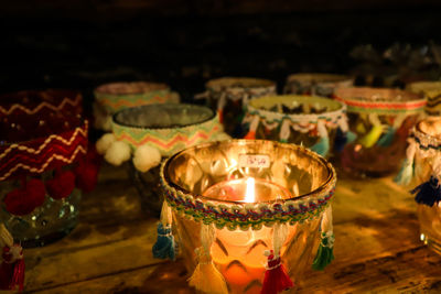 Close-up of lit candles on table