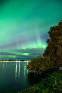 Scenic view of lake against sky at night