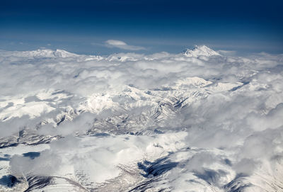 High angle view of clouds over snow covered landscape