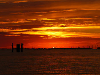 Scenic view of sea against romantic sky at sunset