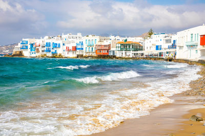 Scenic view of sea and buildings against sky