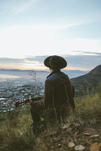 Man playing guitar on mountain