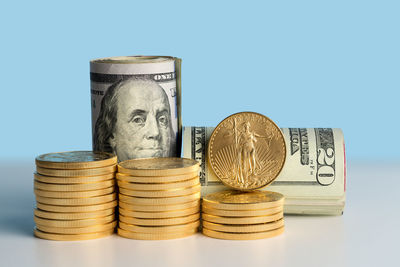 Close-up of coin stack against blue background