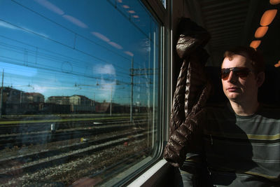 Middle aged man in googles travelling by train. public transport and transportation concept