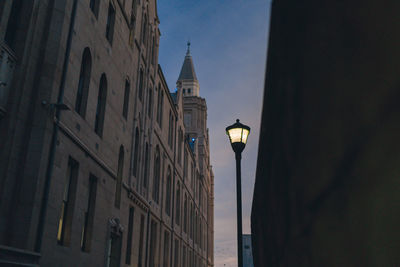Low angle view of street light against building