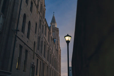 Low angle view of street light against building