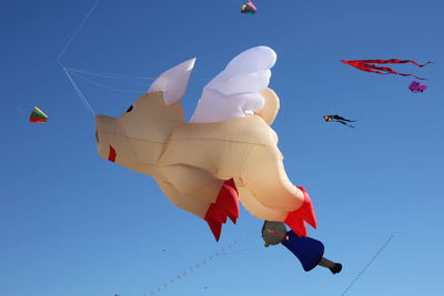 Low angle view of flag against clear blue sky