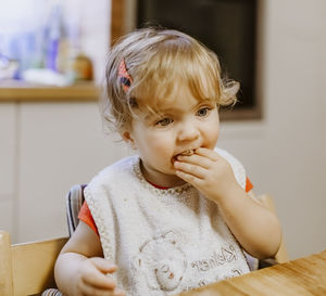Cute girl eating food at home