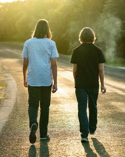 Rear view of two people walking outdoors