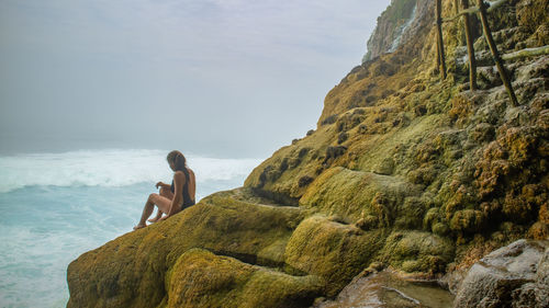 Man looking at sea against sky