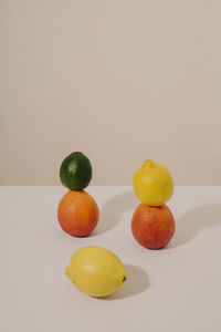 Close-up of fruits on table against white background