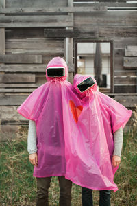 Rear view of man with pink umbrella