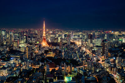 High angle view of city lit up at night