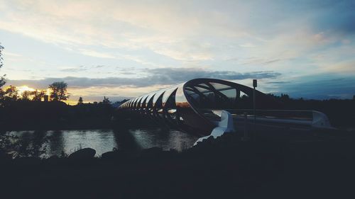 Boats in river at sunset