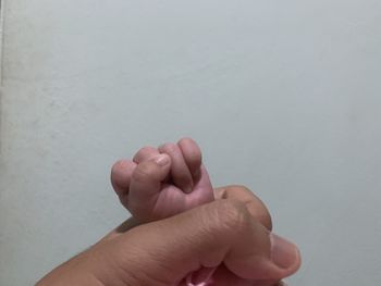 Close-up of human hand against white background