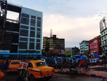 View of city street and buildings against sky