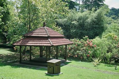 Gazebo on field against trees