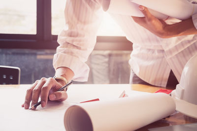 Midsection of woman working on table