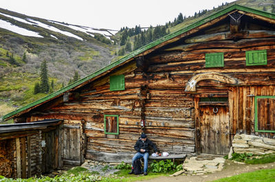 People outside house against building