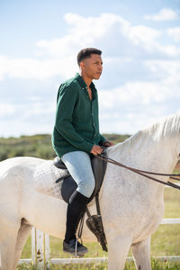 Full length of a man riding horse