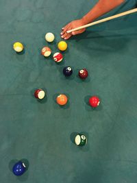 High angle view of person playing pool on table