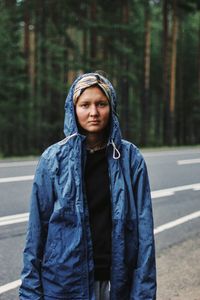 Portrait of young man standing on road