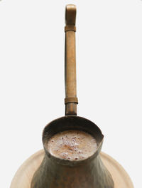 Close-up of coffee cup against white background