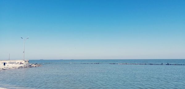 Scenic view of sea against clear blue sky