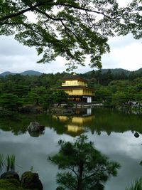 Scenic view of lake by building against sky