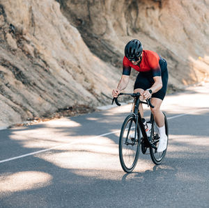 Man riding bicycle on road