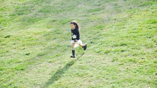 Full length of man standing on grassy field