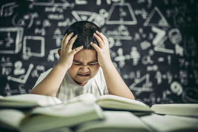Portrait of boy wearing book