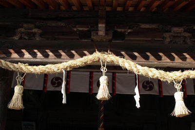 Low angle view of illuminated lighting equipment hanging on ceiling