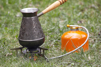 Close-up of tea light on field