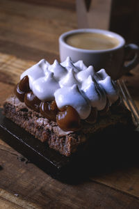 Coffee cup and cake on table