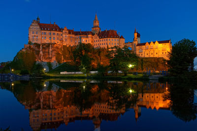 Reflection of illuminated buildings in lake