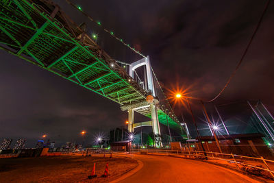 Illuminated road against sky at night