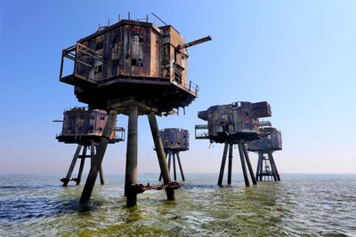 Lifeguard hut in sea against clear sky