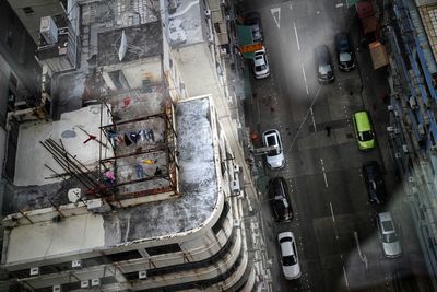 High angle view of vehicles on road amidst buildings in city