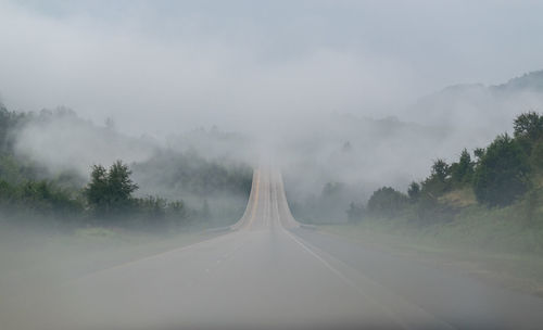 Road and mountains in foggy weather