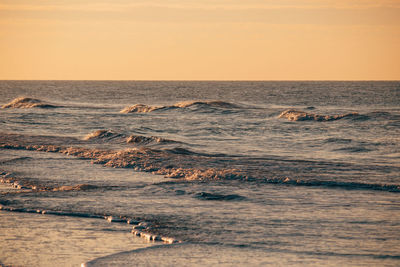 Scenic view of beach against sky during sunset